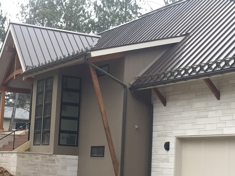 Example of a large transitional two-story stone gable roof design in Indianapolis