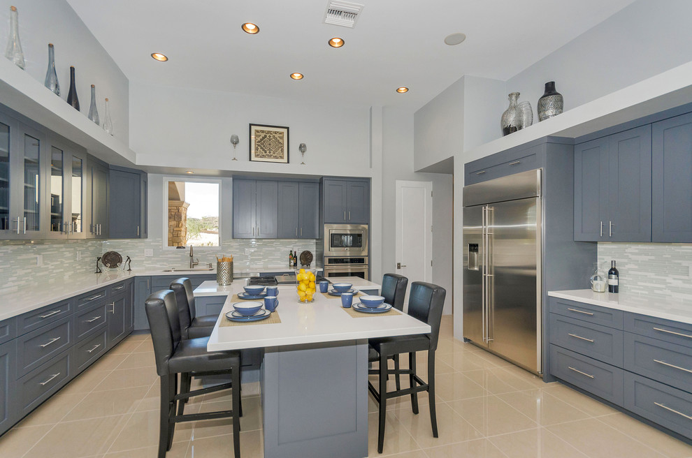 Large transitional l-shaped porcelain tile and beige floor eat-in kitchen photo in Phoenix with an undermount sink, shaker cabinets, blue cabinets, gray backsplash, matchstick tile backsplash, stainless steel appliances, an island and quartz countertops
