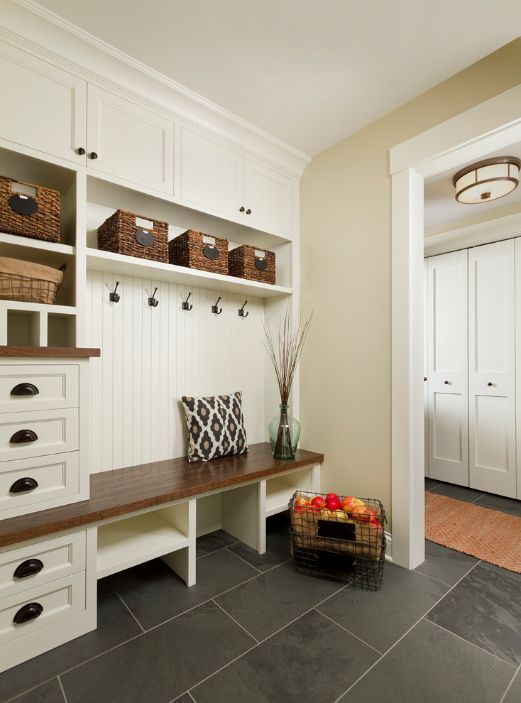 Design ideas for a mid-sized traditional mudroom in Minneapolis with beige walls and slate floors.
