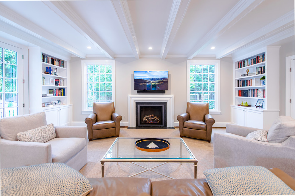 Photo of a transitional enclosed living room in DC Metro with beige walls, medium hardwood floors, a standard fireplace, a wall-mounted tv and brown floor.