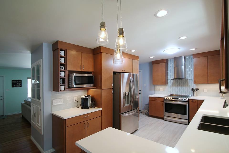 Inspiration for a mid-sized transitional galley eat-in kitchen in Denver with an undermount sink, flat-panel cabinets, medium wood cabinets, quartz benchtops, grey splashback, glass tile splashback, stainless steel appliances, porcelain floors and a peninsula.