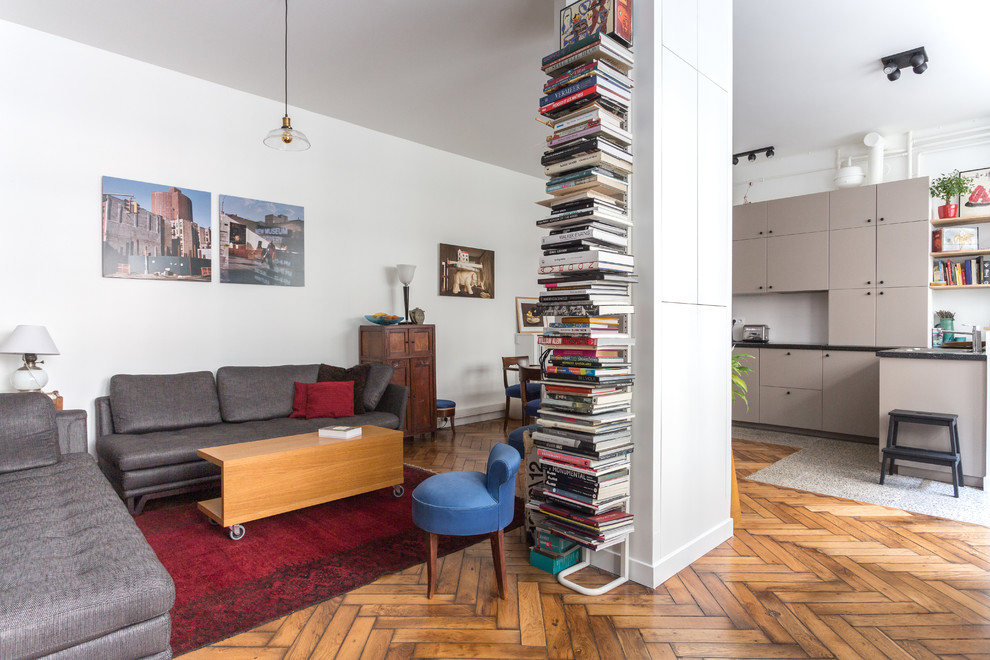 Idée de décoration pour une grande salle de séjour urbaine ouverte avec une bibliothèque ou un coin lecture, un mur blanc, un sol en bois brun, aucune cheminée, un sol marron et aucun téléviseur.