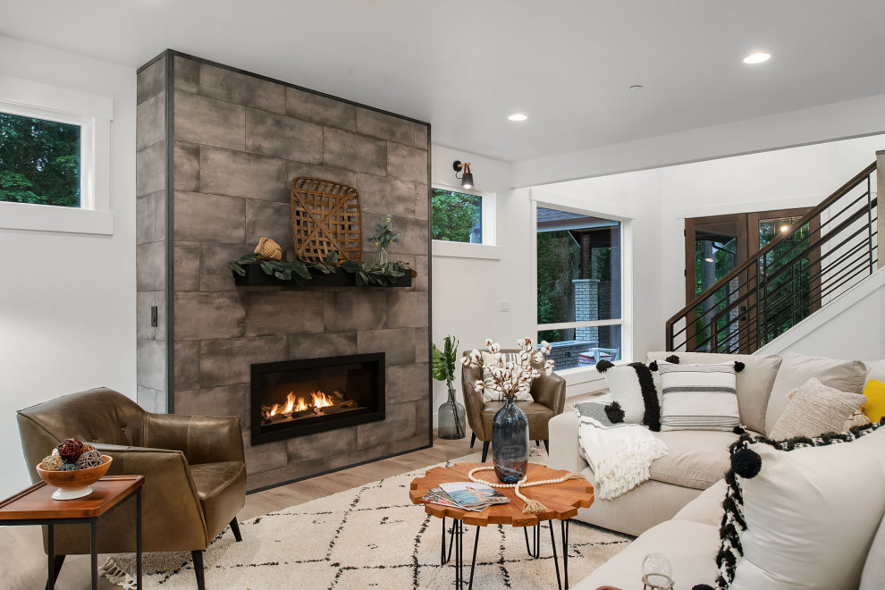 Living room - transitional formal and open concept medium tone wood floor and brown floor living room idea in Seattle with white walls, a standard fireplace, a tile fireplace and no tv