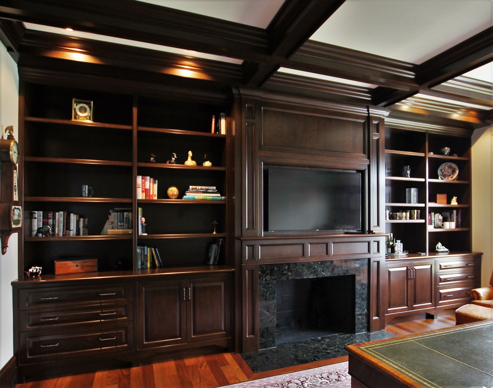 Photo of a large traditional study room in Boston with white walls, medium hardwood floors, a standard fireplace, a stone fireplace surround, a freestanding desk and brown floor.