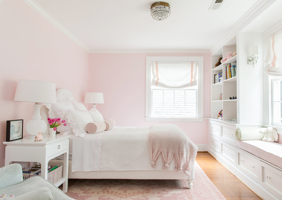 Inspiration for a traditional kids' bedroom for girls in Raleigh with pink walls, medium hardwood floors and beige floor.