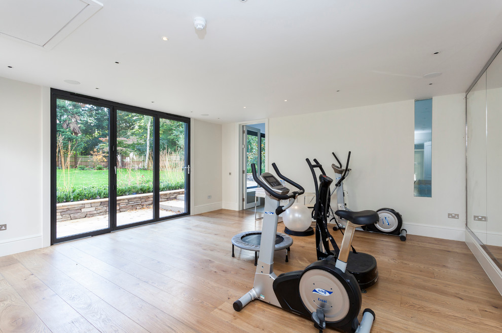 Photo of a traditional home gym in London with white walls.