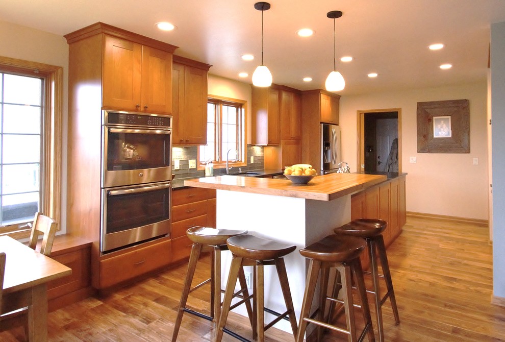 Transitional galley eat-in kitchen photo with recessed-panel cabinets, medium tone wood cabinets, soapstone countertops and an island