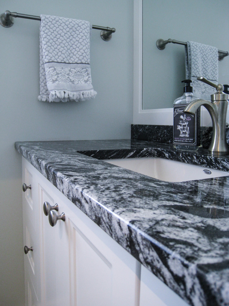 Transitional bathroom photo in Toronto with white cabinets, blue walls, an undermount sink and granite countertops