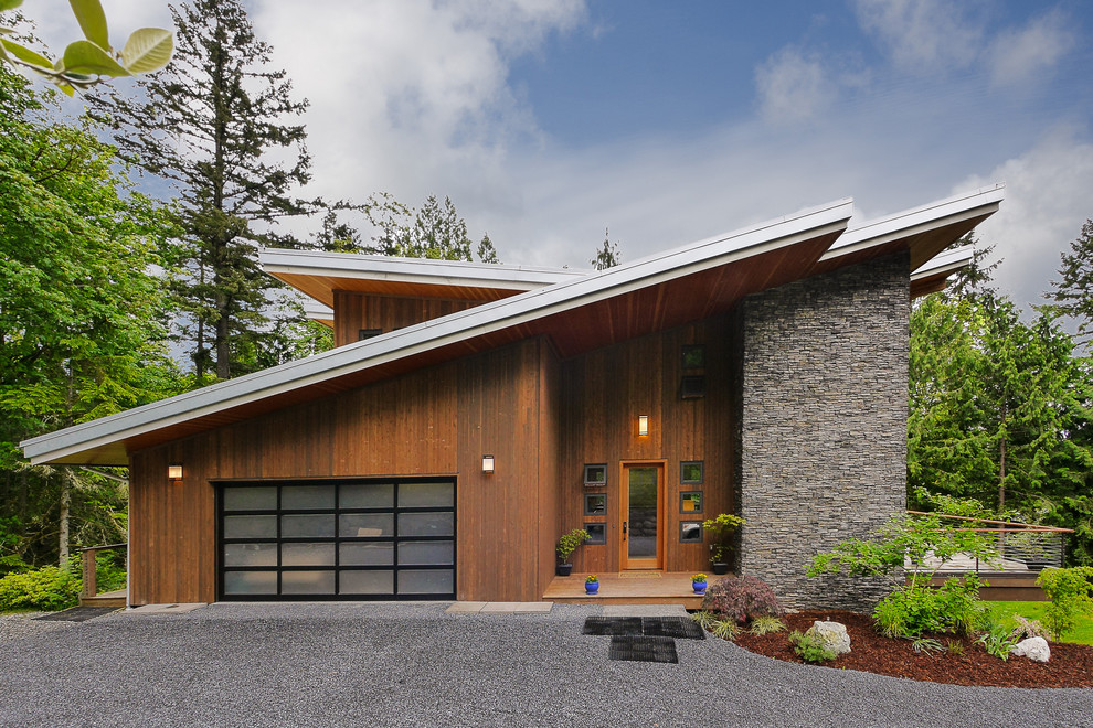Inspiration for a contemporary exterior in Seattle with wood siding and a butterfly roof.