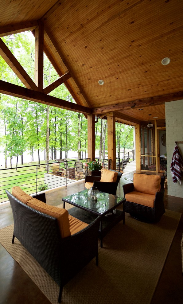 Example of a large mountain style backyard outdoor kitchen deck design