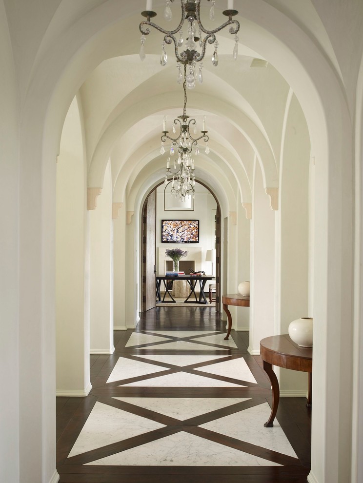 This is an example of a large transitional hallway in Houston with white walls.