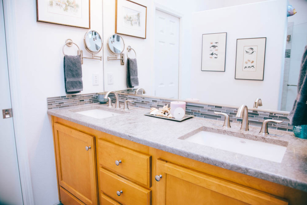 Mid-sized transitional master bathroom in Portland with a curbless shower, a two-piece toilet, multi-coloured tile, glass sheet wall, white walls, an undermount sink, engineered quartz benchtops, a hinged shower door, grey benchtops, a shower seat, a double vanity and a built-in vanity.