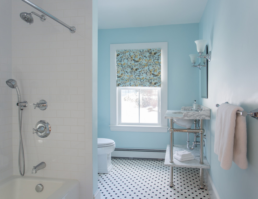 This is an example of a mid-sized country 3/4 bathroom in Boston with a one-piece toilet, black and white tile, ceramic tile, blue walls, ceramic floors, granite benchtops, a shower/bathtub combo and a pedestal sink.