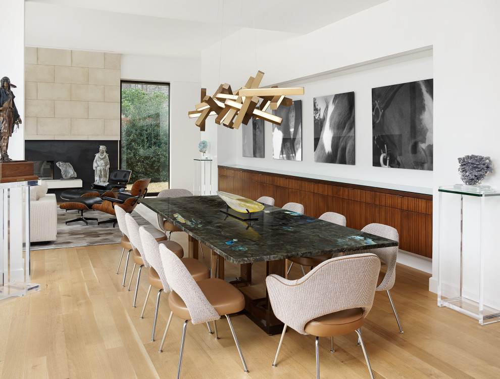 North Dallas - Example of a mid-sized trendy light wood floor and beige floor great room design in Dallas with white walls, a ribbon fireplace and a metal fireplace