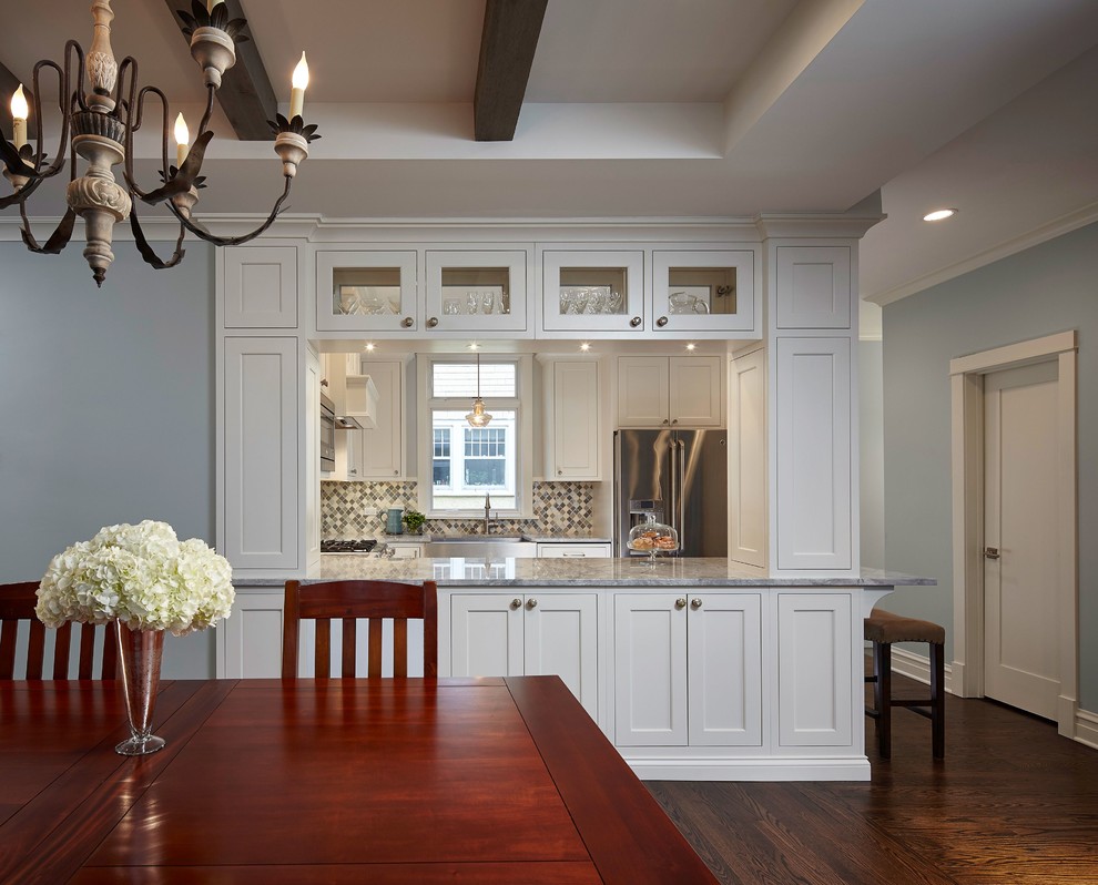 Eat-in kitchen - transitional u-shaped medium tone wood floor eat-in kitchen idea in Chicago with shaker cabinets, white cabinets, quartzite countertops, multicolored backsplash, stainless steel appliances and a peninsula
