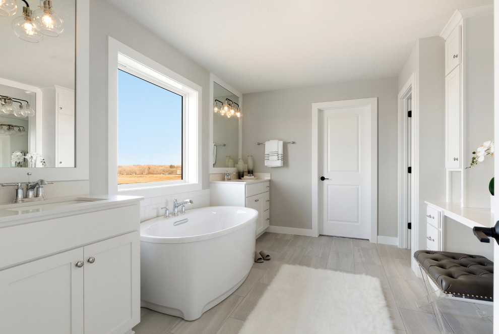 Design ideas for a large transitional master bathroom in Minneapolis with shaker cabinets, white cabinets, a freestanding tub, a corner shower, subway tile, grey walls, ceramic floors, an undermount sink, quartzite benchtops, grey floor, an open shower, white benchtops, an enclosed toilet, a double vanity and a built-in vanity.