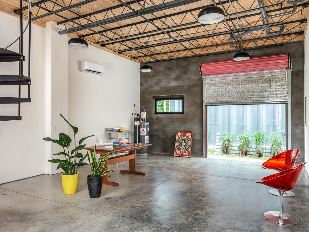 Small industrial home studio in Nashville with white walls and concrete floors.