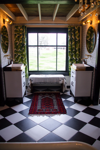 Example of a large farmhouse master black and white tile and ceramic tile ceramic floor and black floor bathroom design in Austin with furniture-like cabinets, a one-piece toilet, pink walls, a vessel sink, wood countertops and brown countertops