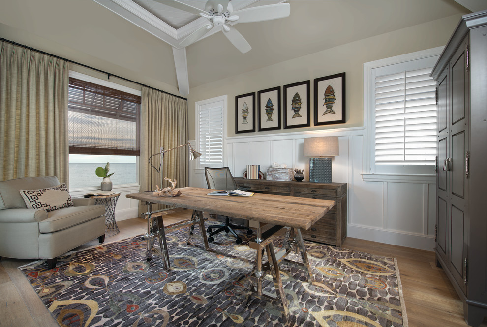 This is an example of a beach style study room in Miami with medium hardwood floors and a freestanding desk.