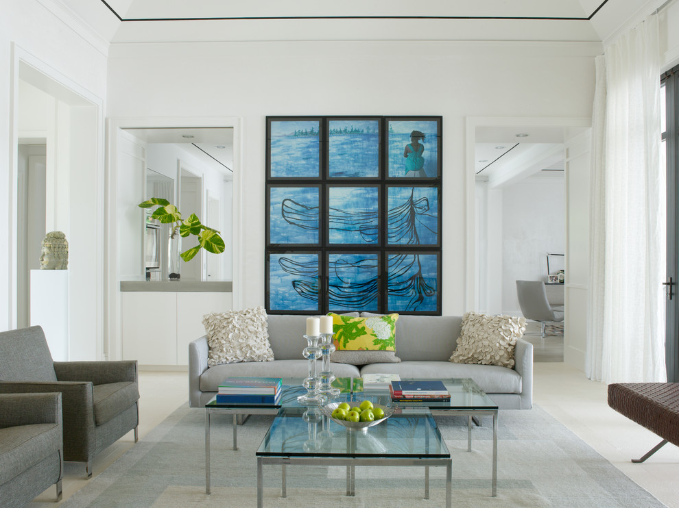 This is an example of a tropical formal enclosed living room in Miami with white walls and no tv.