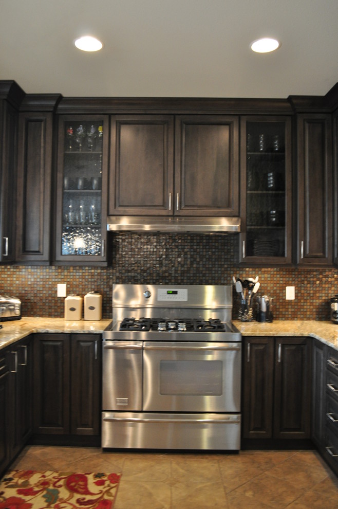 Example of a mid-sized transitional l-shaped porcelain tile eat-in kitchen design in Seattle with an undermount sink, raised-panel cabinets, gray cabinets, granite countertops, multicolored backsplash, mosaic tile backsplash, stainless steel appliances and no island