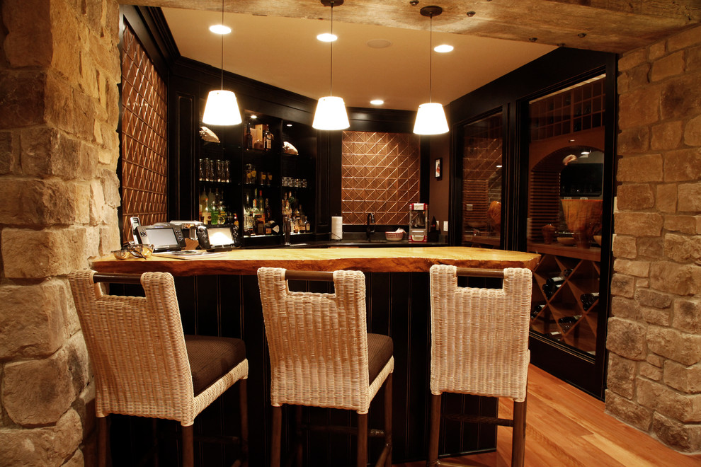 Photo of a traditional home bar in Other.