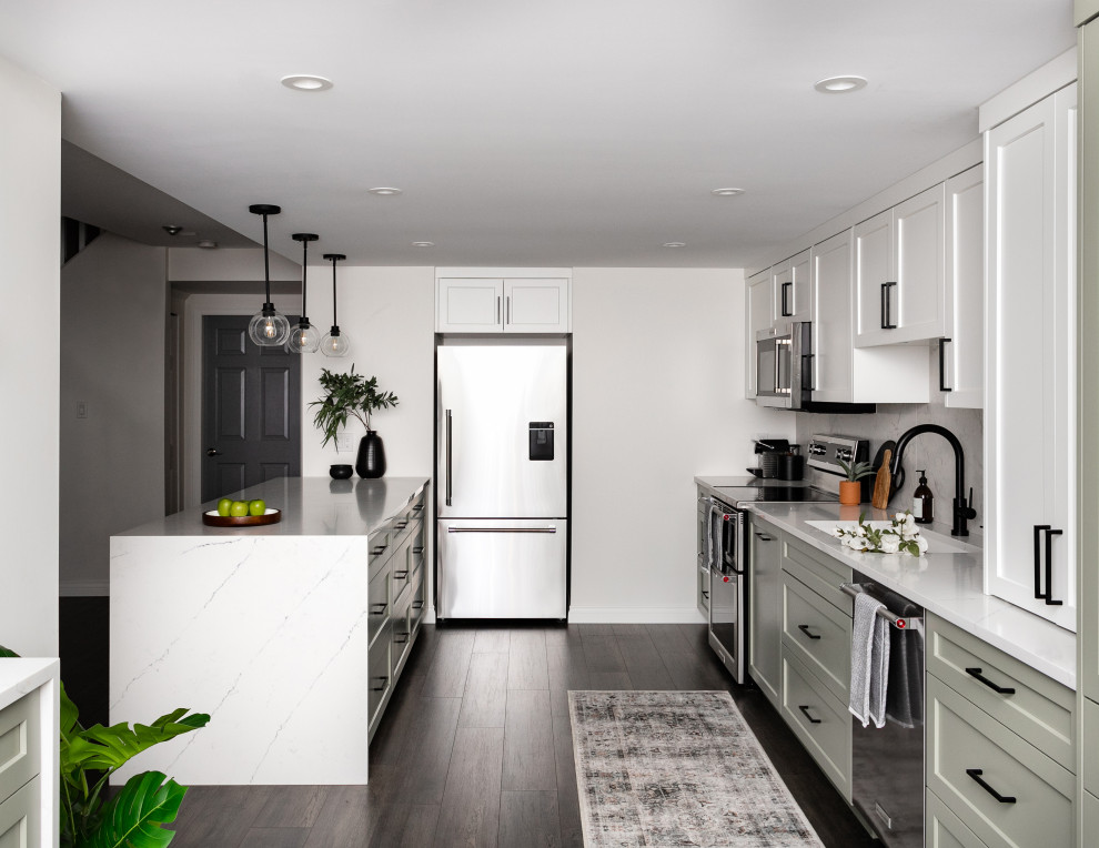 Inspiration for a mid-sized transitional l-shaped laminate floor and brown floor eat-in kitchen remodel in Vancouver with an undermount sink, shaker cabinets, white cabinets, quartzite countertops, white backsplash, ceramic backsplash, stainless steel appliances, a peninsula and white countertops