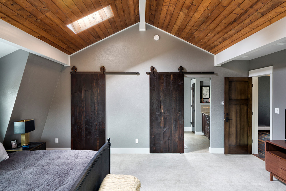 Example of a mid-sized mountain style master carpeted and beige floor bedroom design in Denver with gray walls