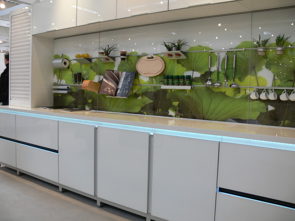 Eat-in kitchen - small modern single-wall medium tone wood floor and beige floor eat-in kitchen idea with an undermount sink, flat-panel cabinets, gray cabinets, quartz countertops, beige backsplash, glass sheet backsplash, stainless steel appliances and no island