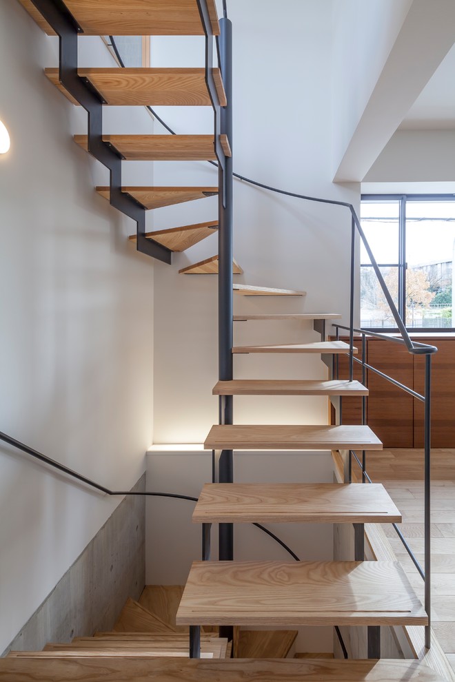 Design ideas for a small asian wood u-shaped staircase in Nagoya with open risers and metal railing.