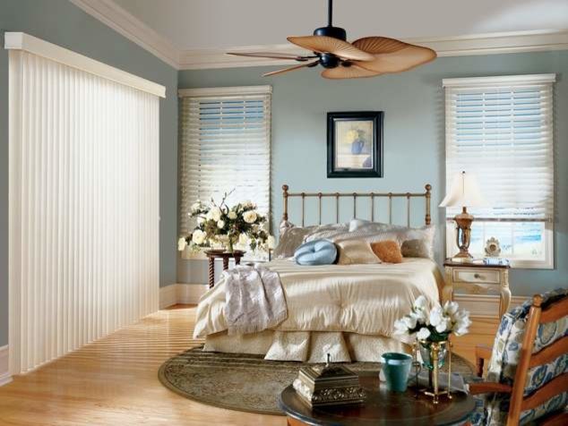 Mid-sized country guest bedroom in Tampa with blue walls, light hardwood floors and no fireplace.