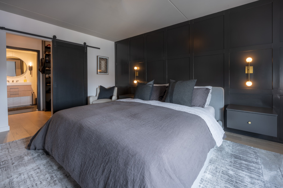 Inspiration for a contemporary master bedroom in Philadelphia with black walls, light hardwood floors and wood walls.