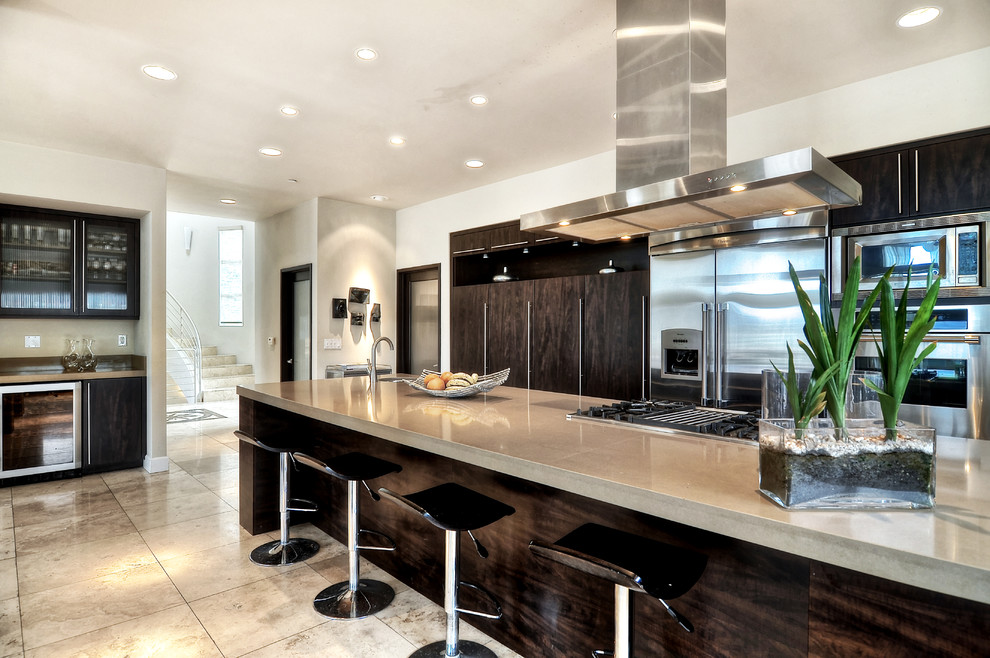 Design ideas for a large modern galley separate kitchen in Orange County with an undermount sink, flat-panel cabinets, dark wood cabinets, quartzite benchtops, stainless steel appliances, limestone floors, beige floor and with island.