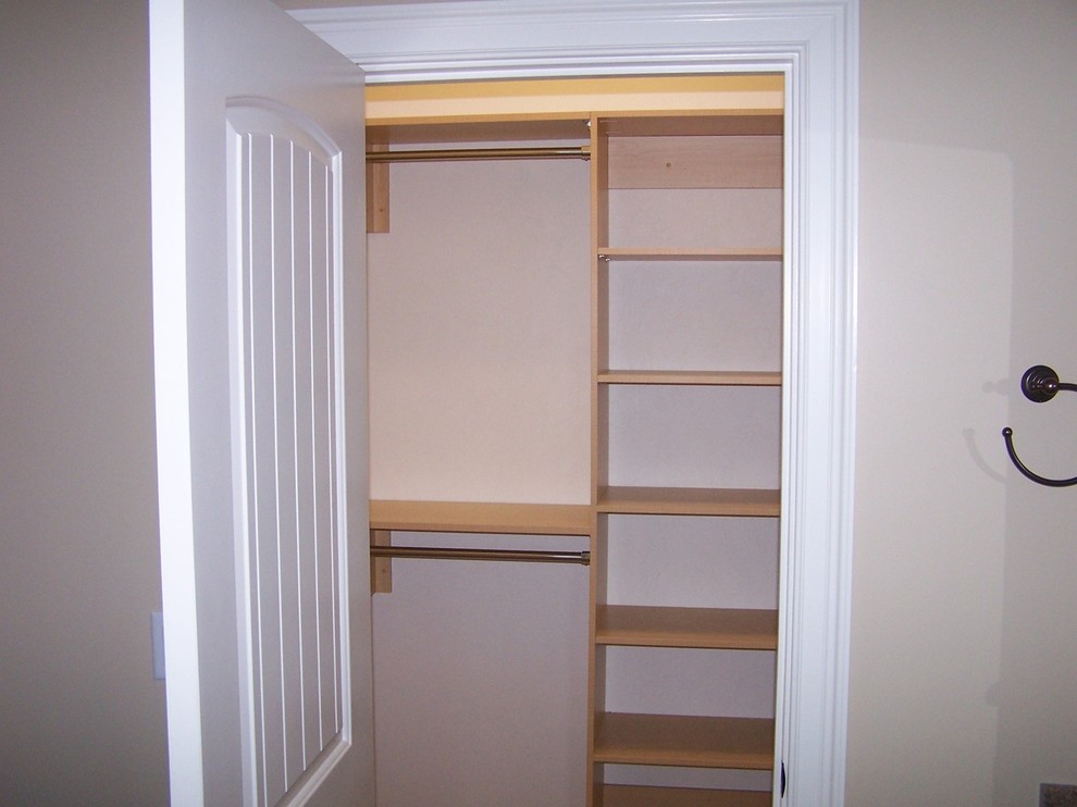 Traditional storage and wardrobe in Portland Maine with light wood cabinets.