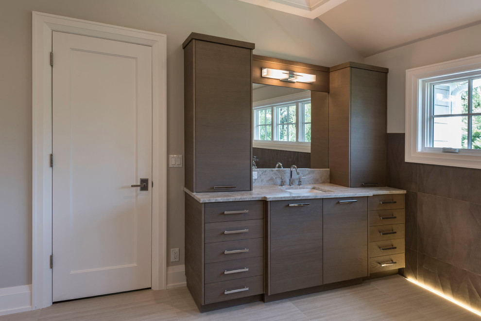 Large traditional master bathroom in Chicago with flat-panel cabinets, light wood cabinets, brown tile, ceramic tile, beige walls, ceramic floors, a drop-in sink, marble benchtops, beige floor and beige benchtops.