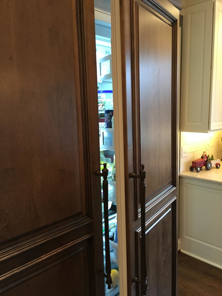 Large transitional u-shaped dark wood floor eat-in kitchen photo in Indianapolis with an undermount sink, raised-panel cabinets, white cabinets, granite countertops, white backsplash, subway tile backsplash, stainless steel appliances and an island