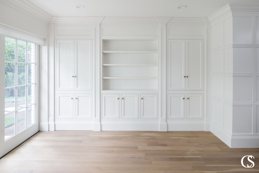 Modelo de salón para visitas cerrado de estilo de casa de campo de tamaño medio con paredes blancas, suelo de madera clara, estufa de leña, suelo marrón y panelado