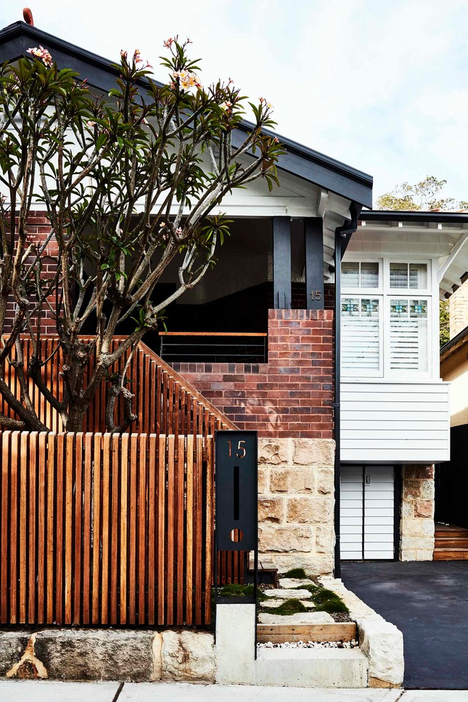Inspiration for a mid-sized contemporary two-storey brick white townhouse exterior in Sydney.