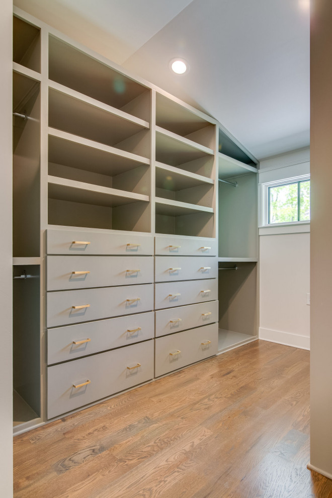 Design ideas for a large classic gender neutral walk-in wardrobe in Nashville with flat-panel cabinets, grey cabinets and medium hardwood flooring.