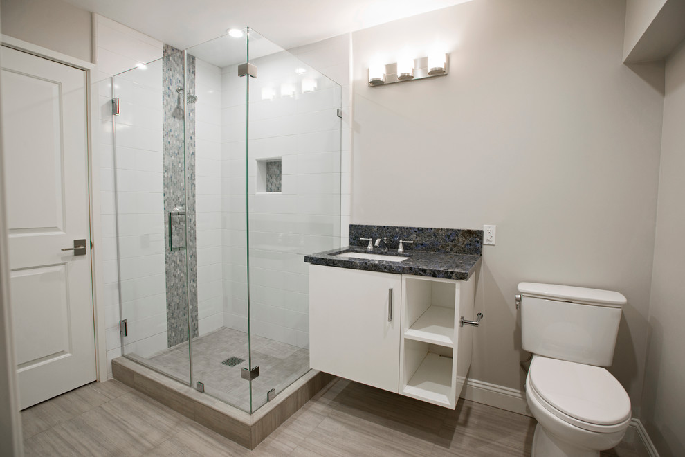 Design ideas for a mid-sized contemporary 3/4 bathroom in Los Angeles with flat-panel cabinets, white cabinets, a corner shower, a two-piece toilet, gray tile, white tile, subway tile, beige walls, painted wood floors, an undermount sink and quartzite benchtops.