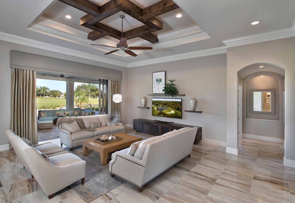 This is an example of a mid-sized mediterranean formal open concept living room in Miami with beige walls, no fireplace, a wall-mounted tv and multi-coloured floor.
