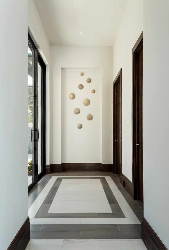 Mid-sized modern hallway in Miami with white walls, porcelain floors and multi-coloured floor.