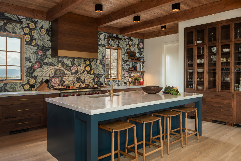 Photo of a country u-shaped kitchen in Other with a submerged sink, shaker cabinets, medium wood cabinets, multi-coloured splashback, stainless steel appliances, light hardwood flooring, an island, beige floors, white worktops, exposed beams and a wood ceiling.