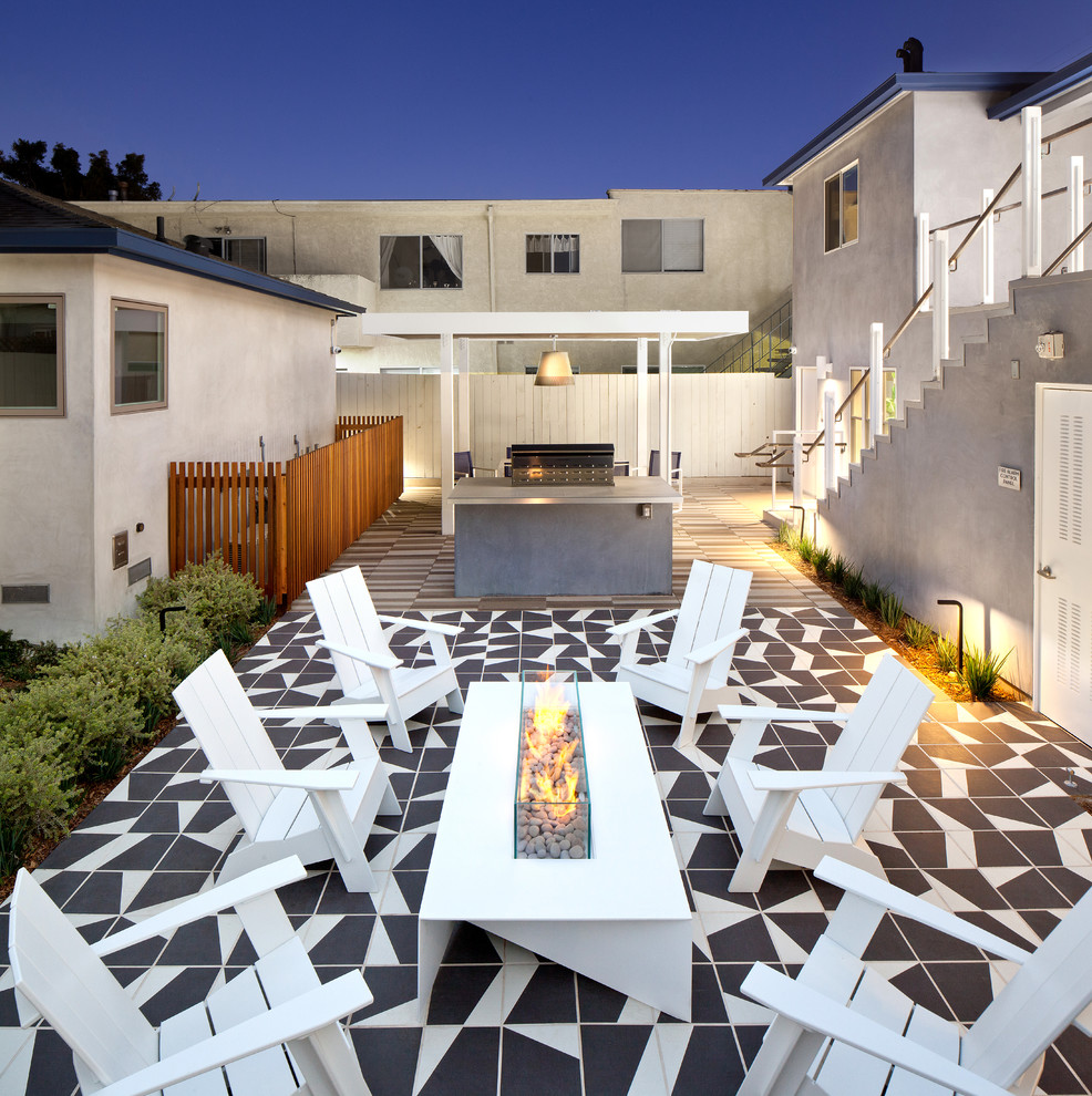 Contemporary patio in Los Angeles with a fire feature, tile and no cover.