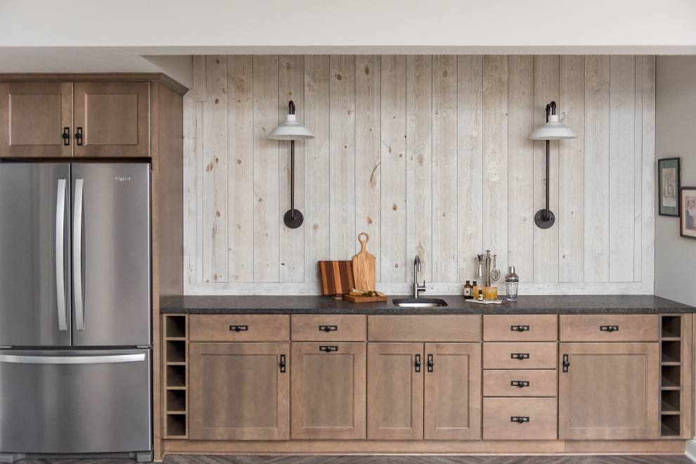 Example of a mid-sized transitional l-shaped dark wood floor enclosed kitchen design in Indianapolis with an undermount sink, shaker cabinets, white cabinets, gray backsplash, stainless steel appliances, an island and beige countertops
