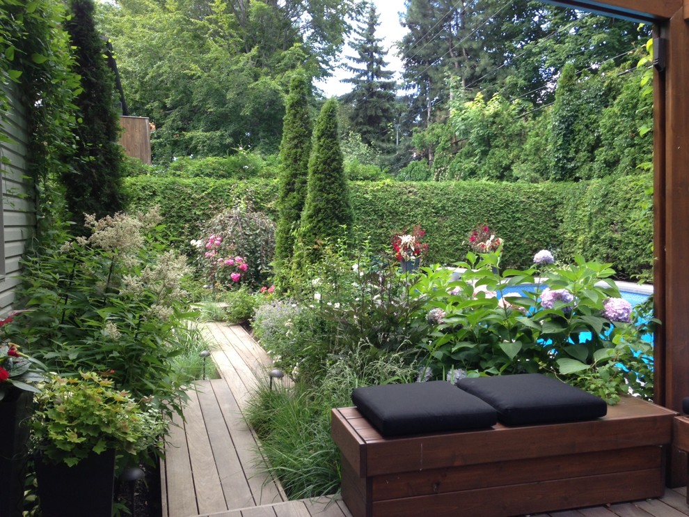 Photo of a contemporary backyard shaded xeriscape in Montreal with decking.
