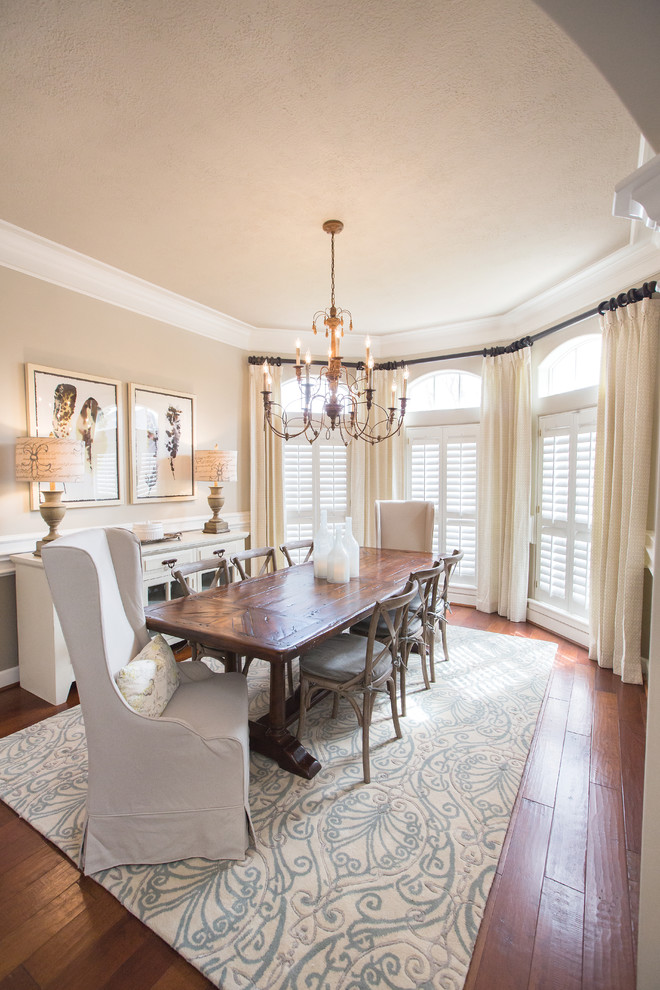 This is an example of a traditional dining room in Dallas with beige walls and dark hardwood floors.