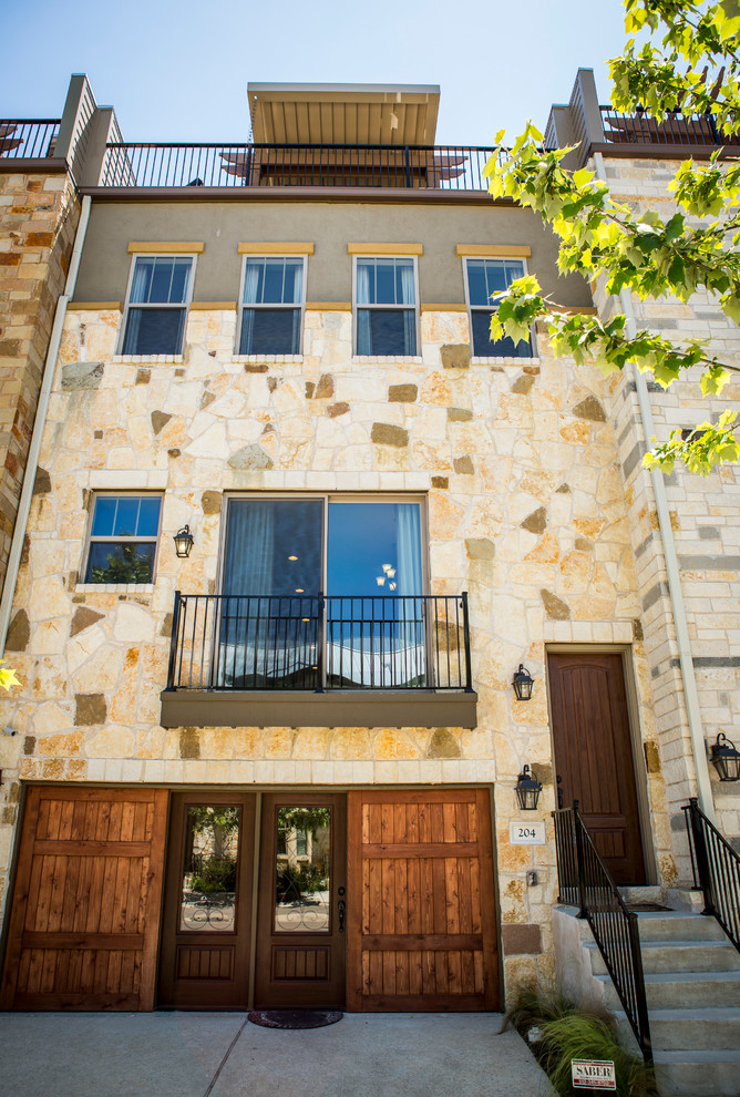 Example of a huge transitional beige three-story stone exterior home design in Austin with a hip roof