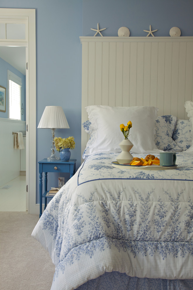This is an example of a beach style master bedroom in Boston.