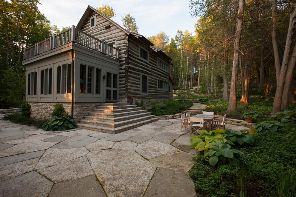 Inspiration for a large rustic partial sun side yard stone landscaping for summer.